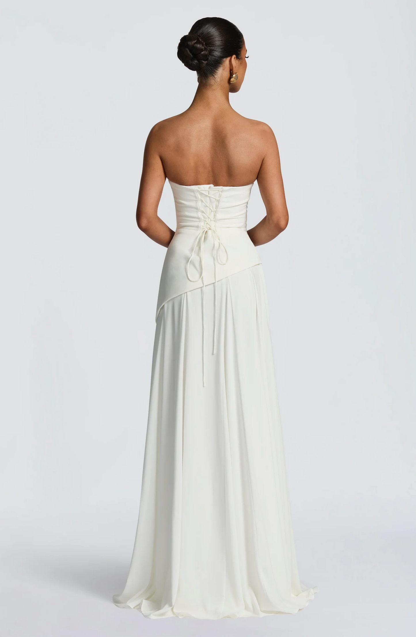 Ivory strapless cowl neck maxi dress with lace-up corset back and flowing hem
