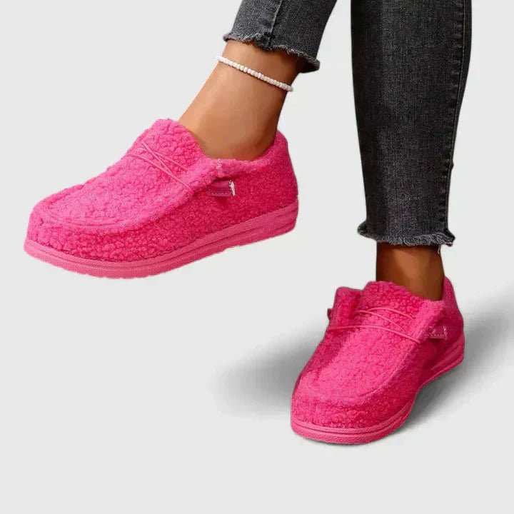 pink fleece moccasin loafers with fuzzy wool exterior and matching sole
