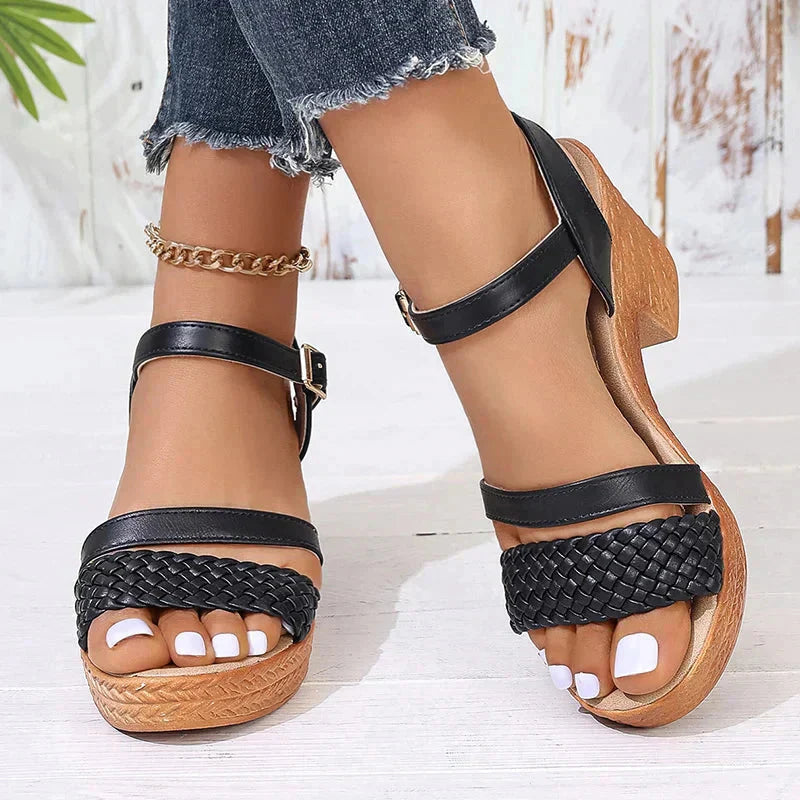 Black woven platform block heel sandals with tan wooden sole and straps
