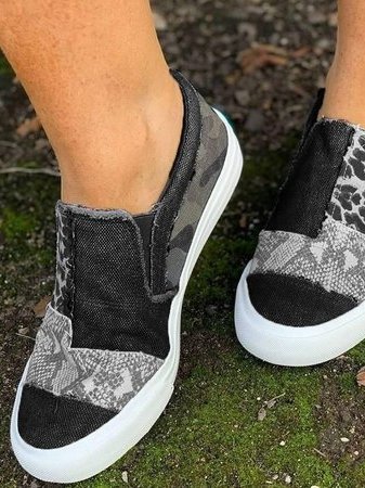 Side view of black and gray leopard print canvas slip-on sneaker with cushioned sole