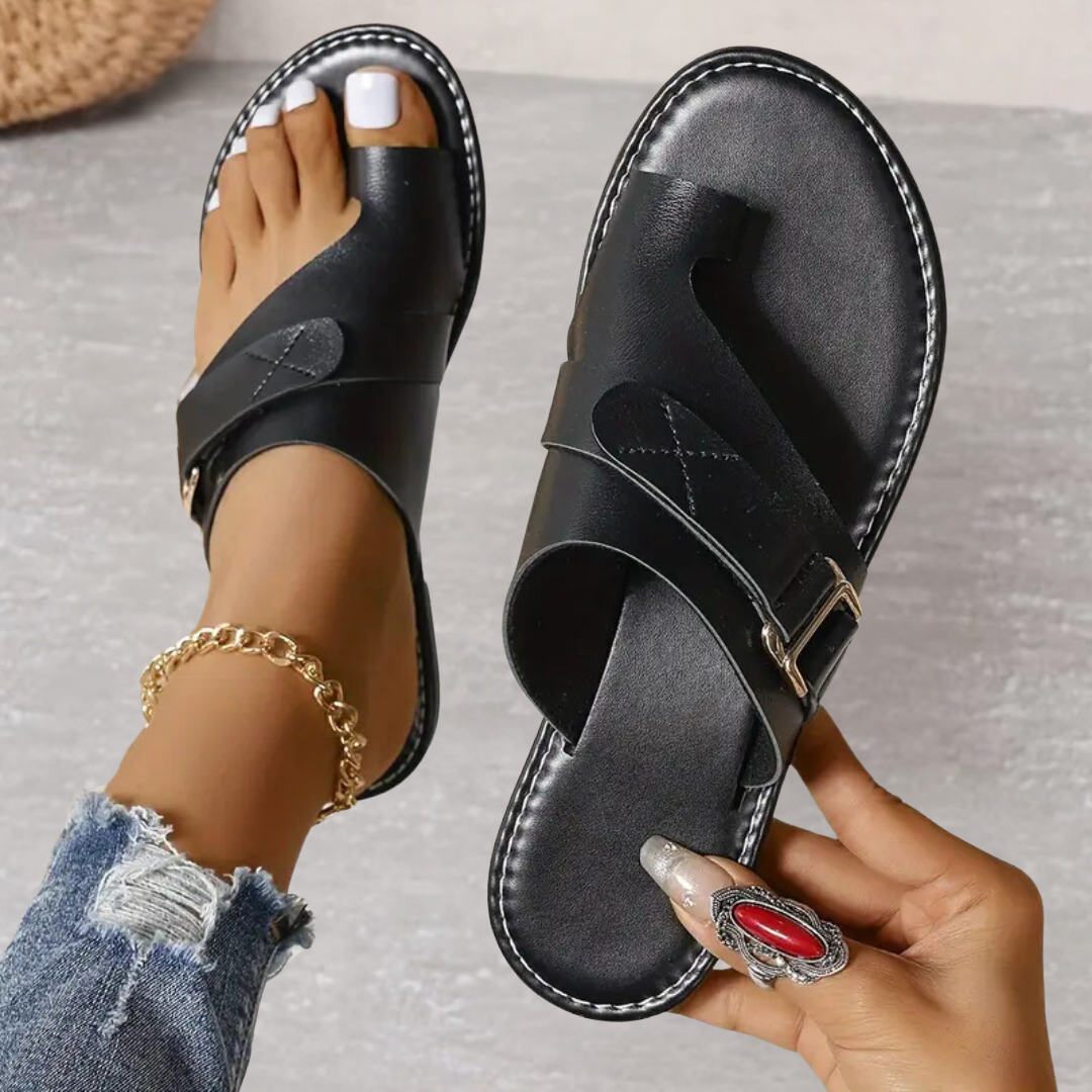 Black orthopedic cross strap sandal with cushioned sole and adjustable ankle strap
