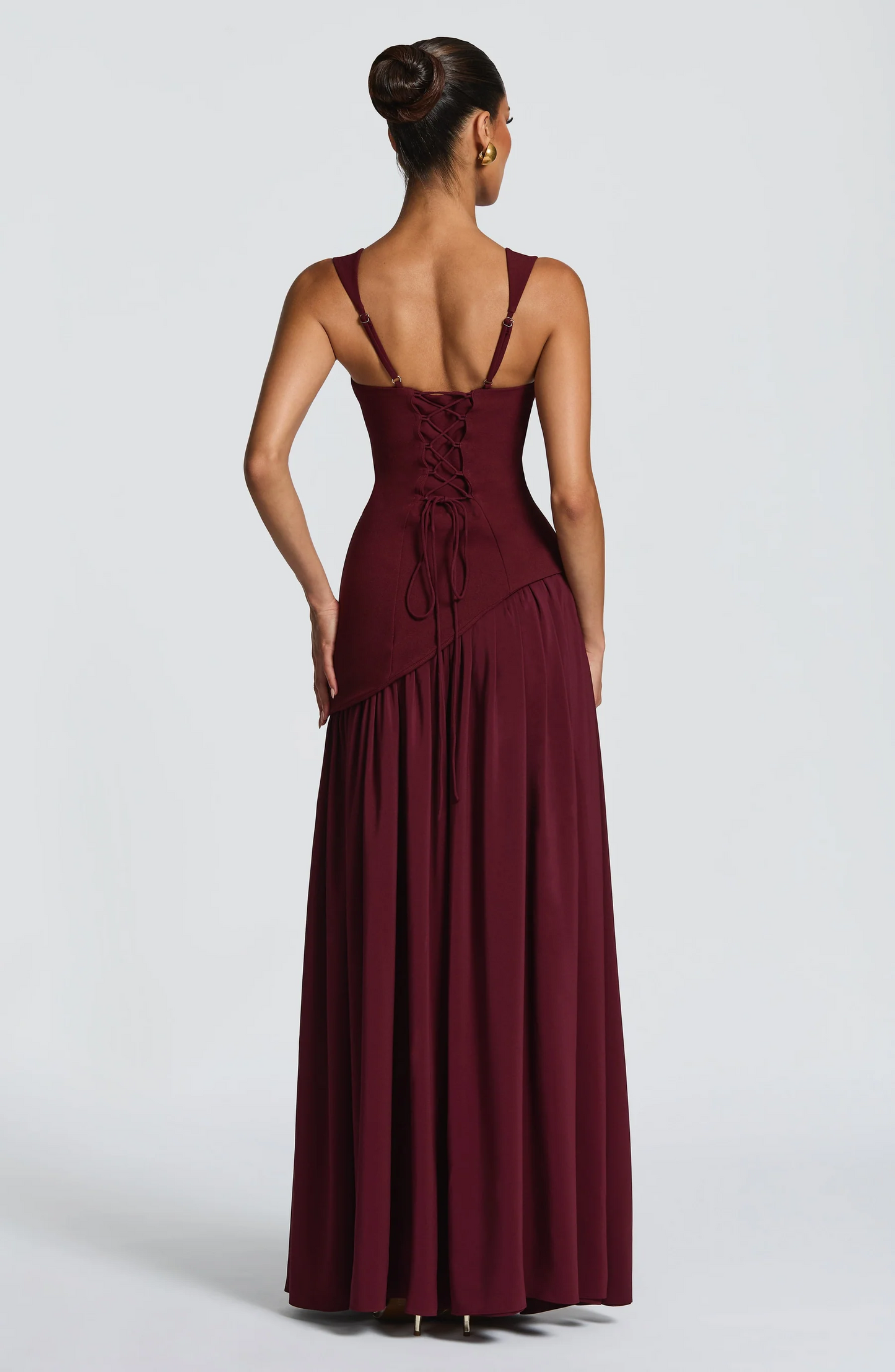 Burgundy maxi dress back view displaying lace-up corset and pleated skirt