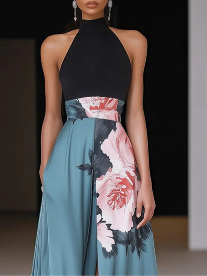 Front view of halter floral maxi dress with red and pink peonies, black leaves, and flowing teal skirt