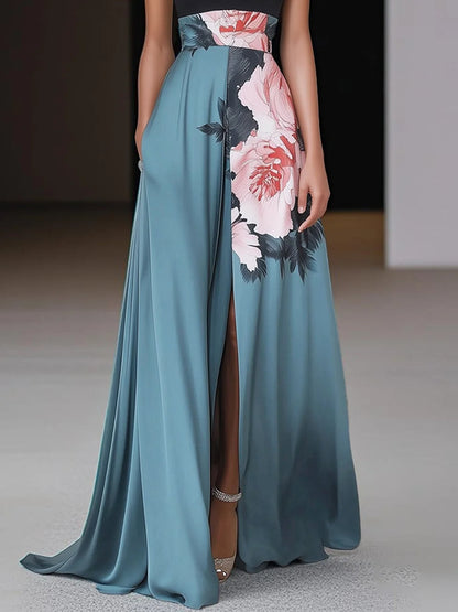 Side detail of floral maxi dress showing high slit, teal fabric drape, and peony print panel