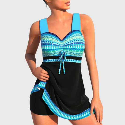 Women's patterned tankini swimsuit with blue geometric print top and black skirt bottom
