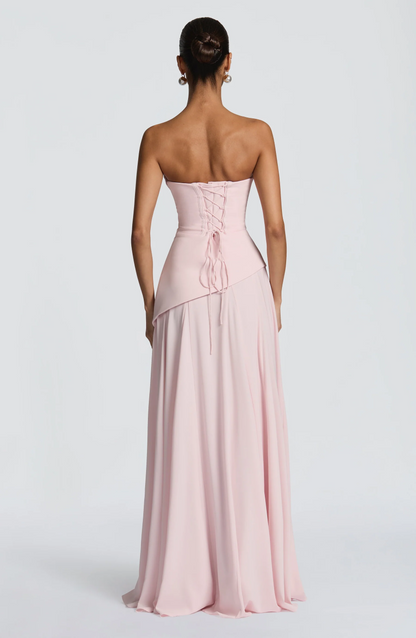 Blush pink strapless maxi dress with lace-up corset back and draped bodice
