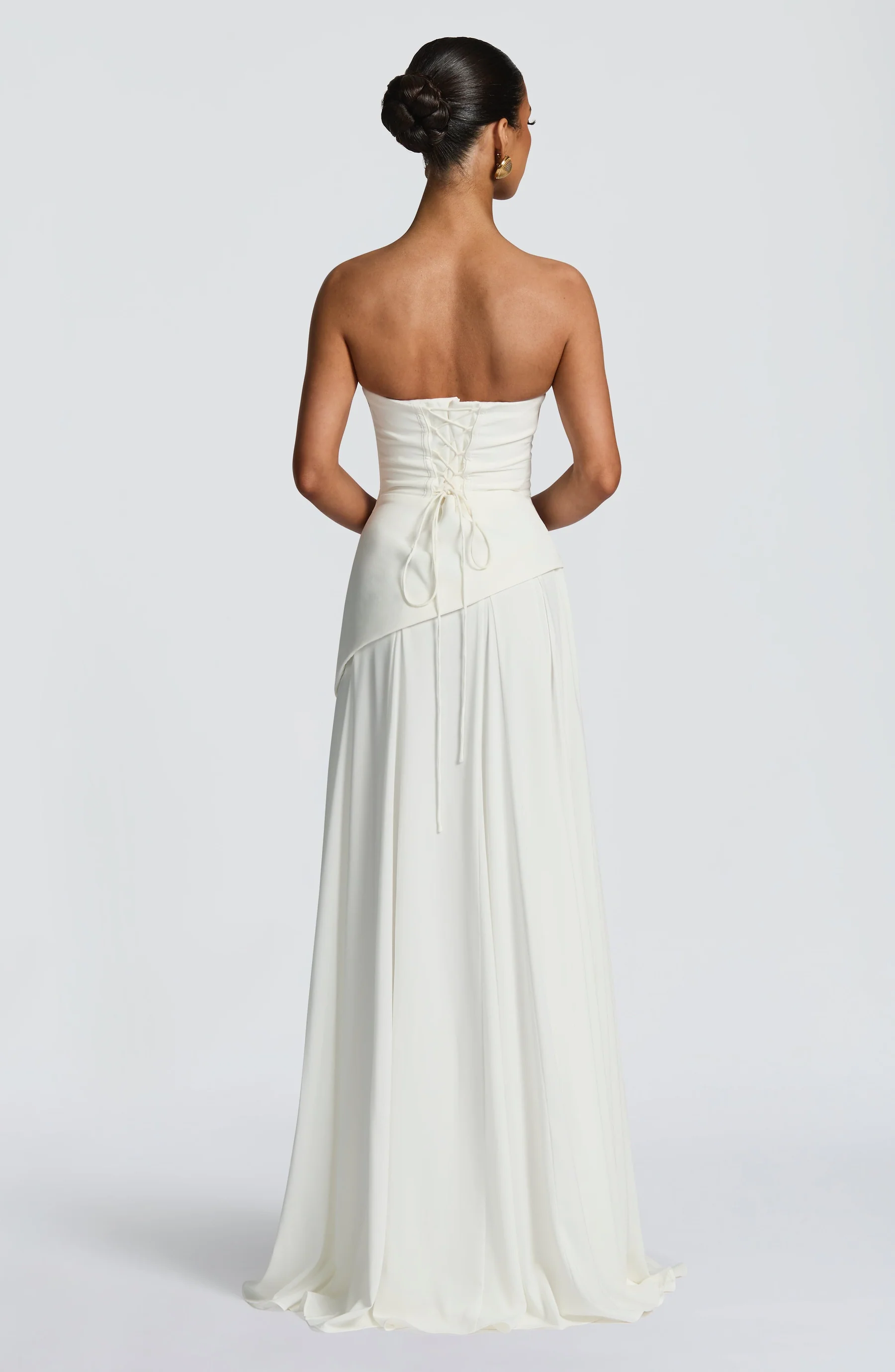 Ivory strapless cowl neck maxi dress with lace-up corset back and flowing hem