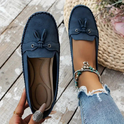 Navy and tan suede bow loafers showing cushioned insole and top view