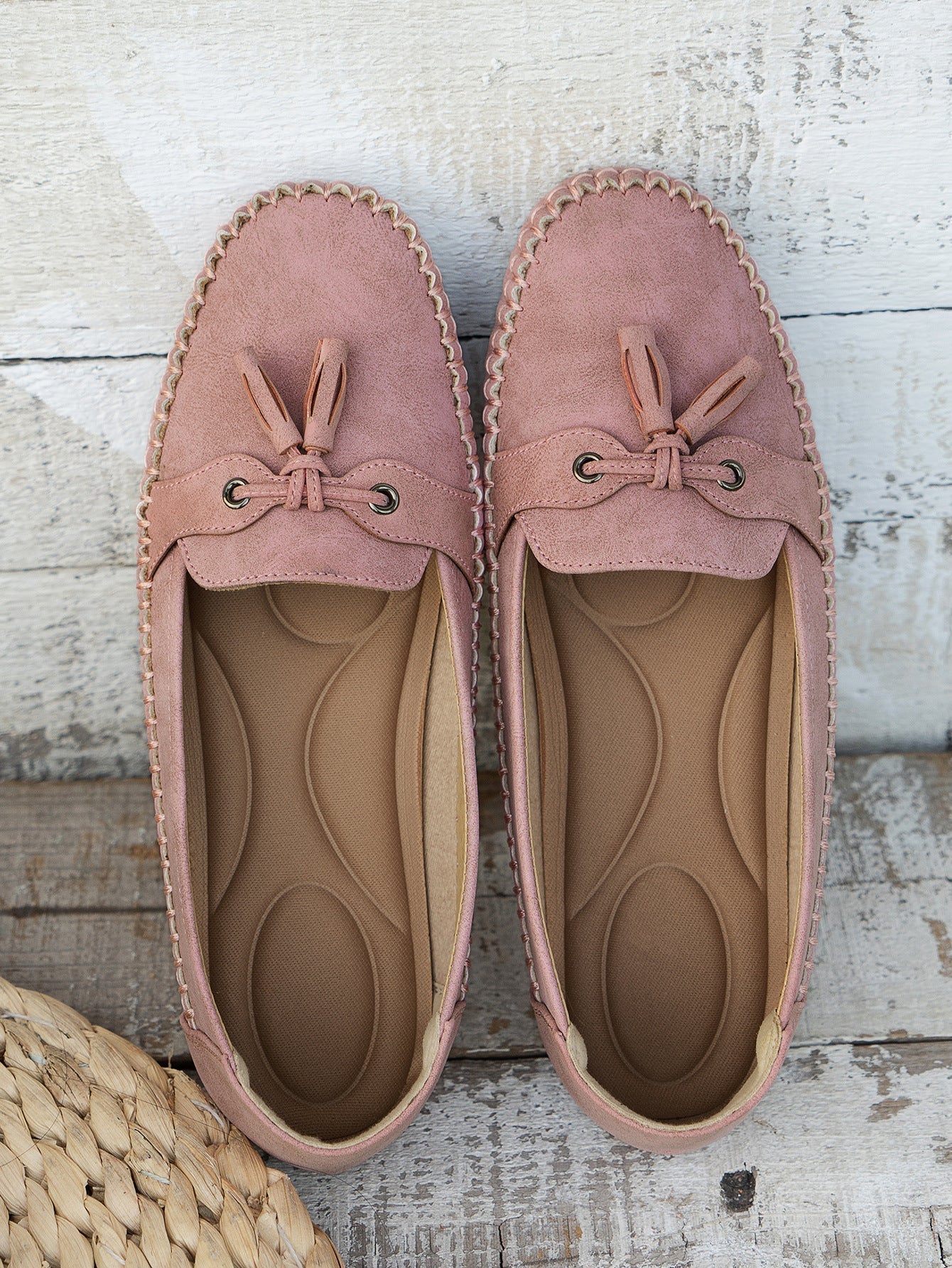 Mauve suede bow loafers pair with cushioned sole, top-down view