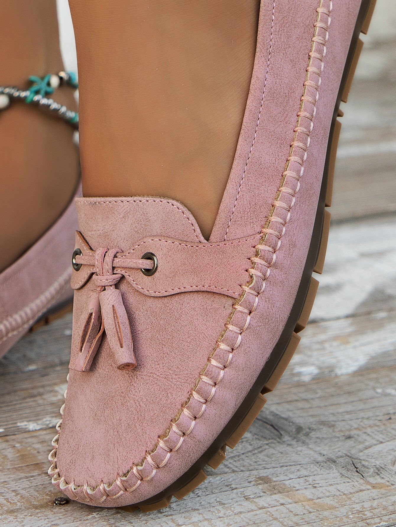 Mauve suede bow loafer side view showing cushioned sole and stitched edge