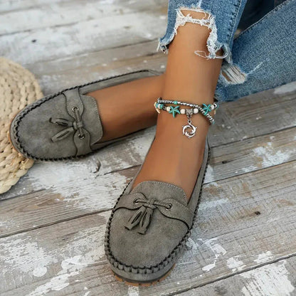 Khaki suede bow loafer showing cushioned insole and stitched moccasin construction