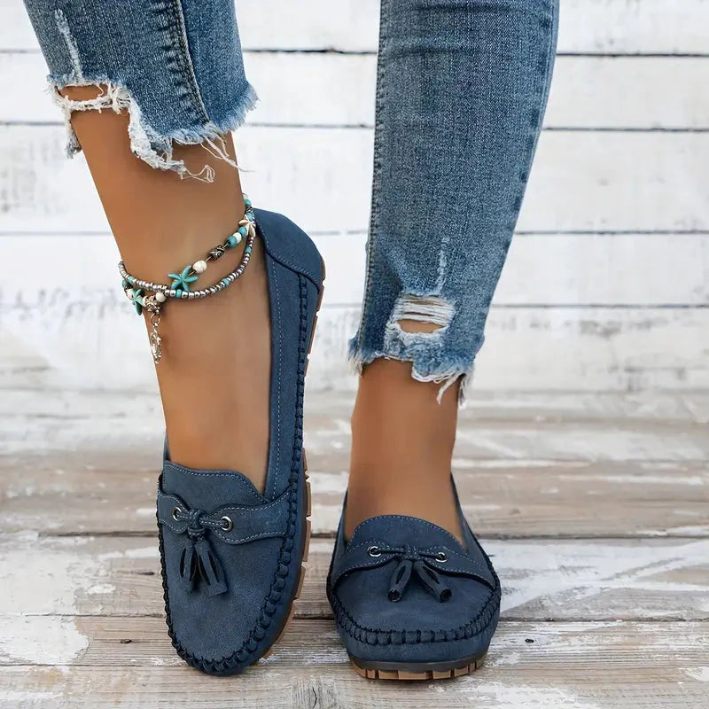 Navy suede loafer with bow detail and cushioned platform sole, side view