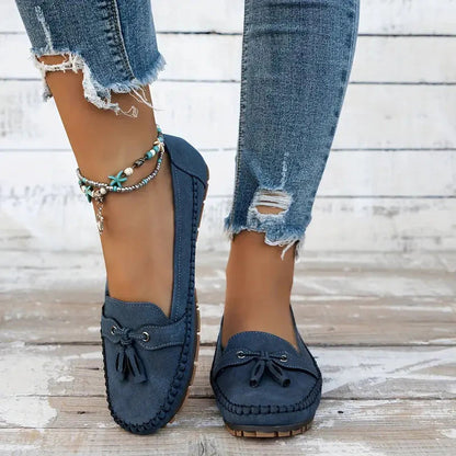 Navy suede loafer with bow detail and cushioned platform sole, side view