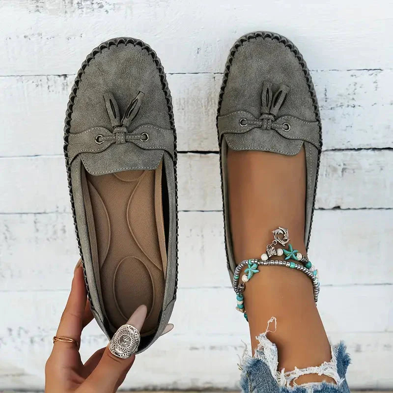 Sage green suede bow loafers showing cushioned insole and moccasin stitching detail