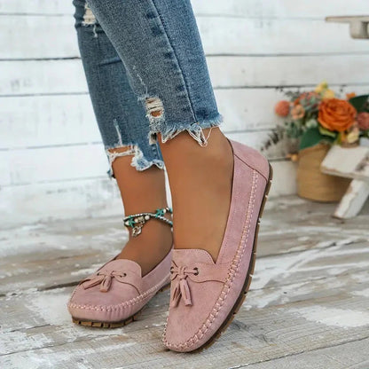 Blush pink suede loafer with bow and cushioned sole, side profile view
