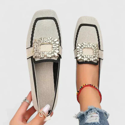 Cream and black knit loafer with gold decorative buckle, shown flat and on foot