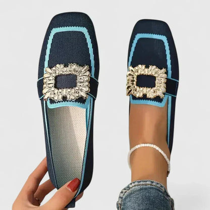 Navy and turquoise knit loafer with gold decorative buckle detail, shown flat and on foot
