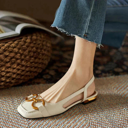 Cream leather loafer flat with gold metal buckle and slingback strap detail