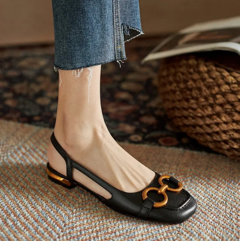Black leather loafer flat with gold hardware buckle and open slingback design
