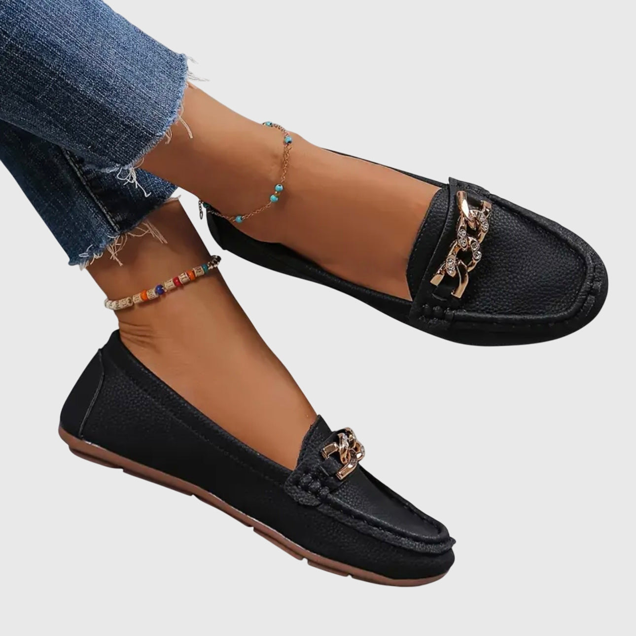 Black textured chain link loafers worn with distressed jeans