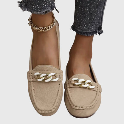 Beige leather loafers with white and gold chain link detail on top