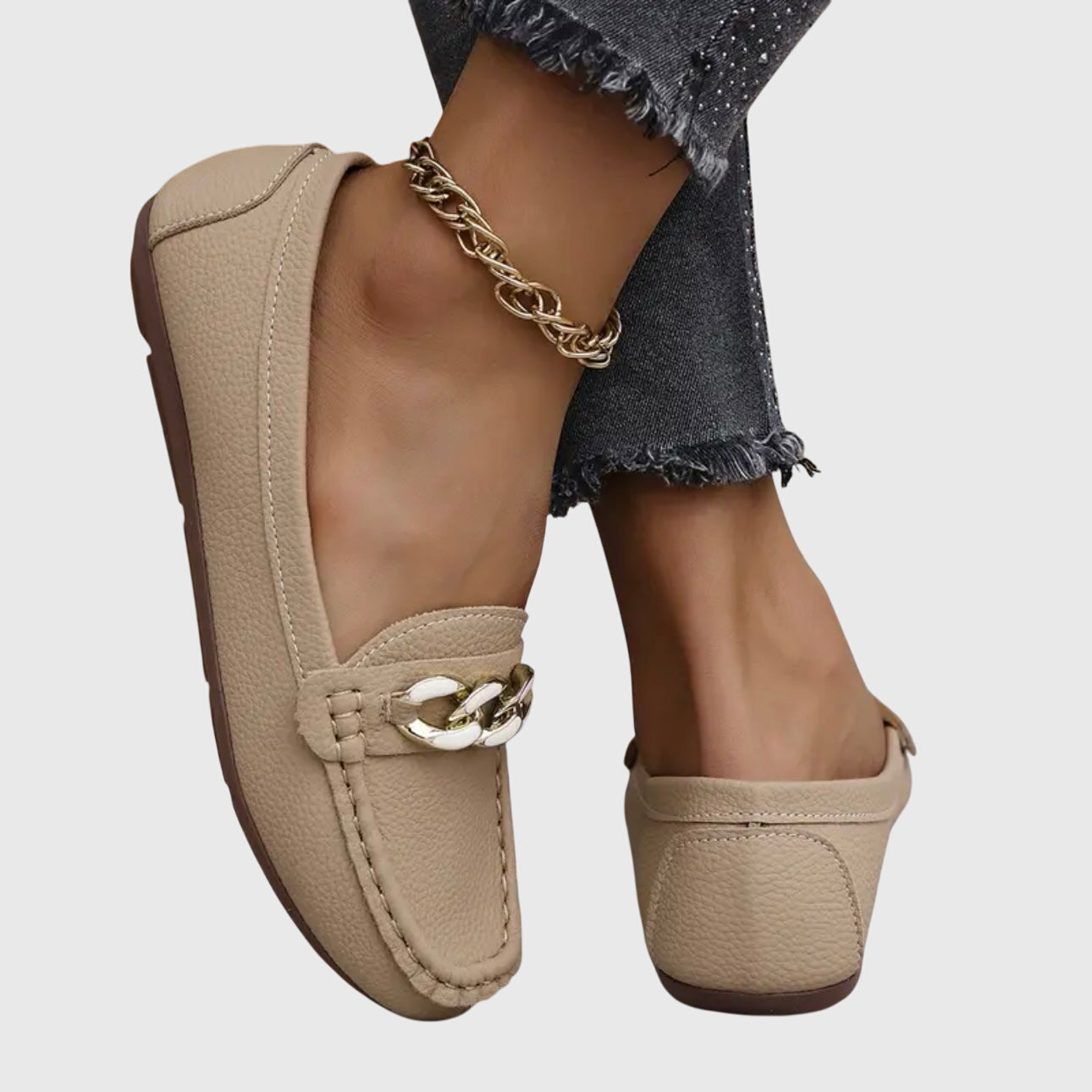 Side view of beige leather loafer with chain link embellishment