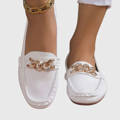 White leather loafers with rose gold chain link hardware