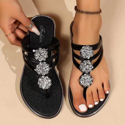 Black thong sandals with rhinestone t-strap featuring three round crystal clusters