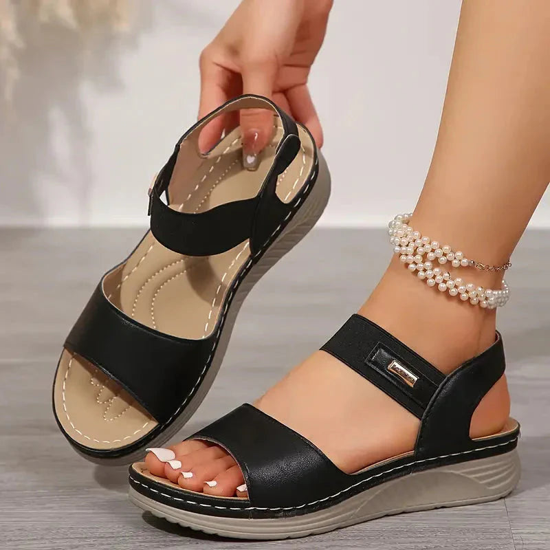Black adjustable platform sandal with ankle strap and metallic buckle detail