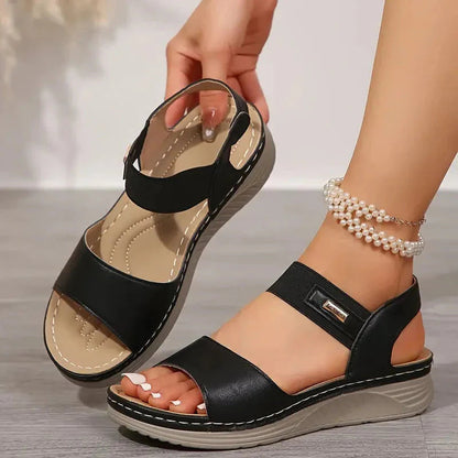 Black adjustable platform sandal with ankle strap and metallic buckle detail