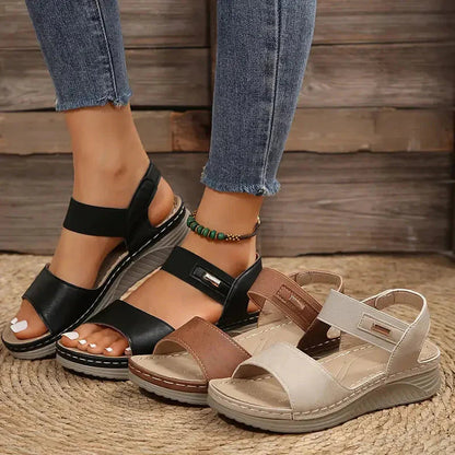 Black, brown, and cream adjustable platform sandals with ankle straps displayed together