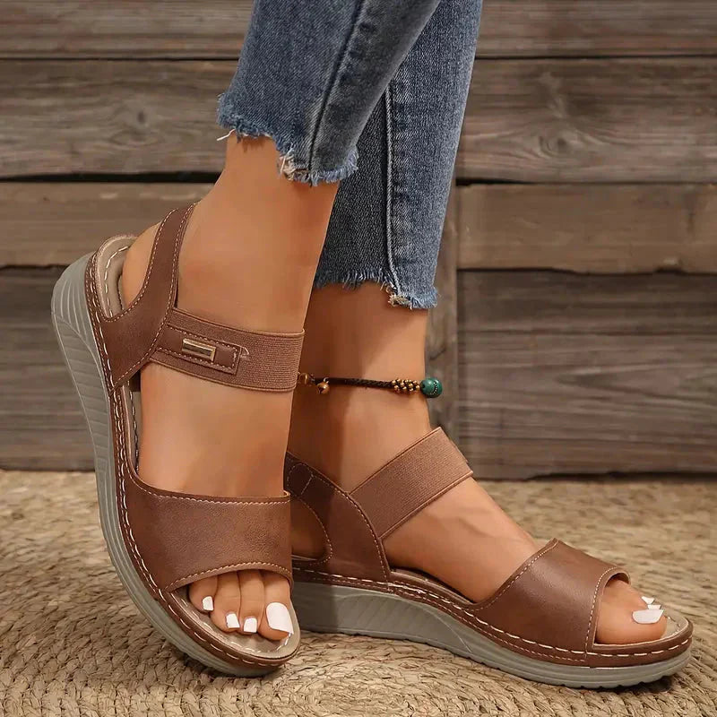 Brown adjustable platform sandal with ankle strap and stitched detailing on sole