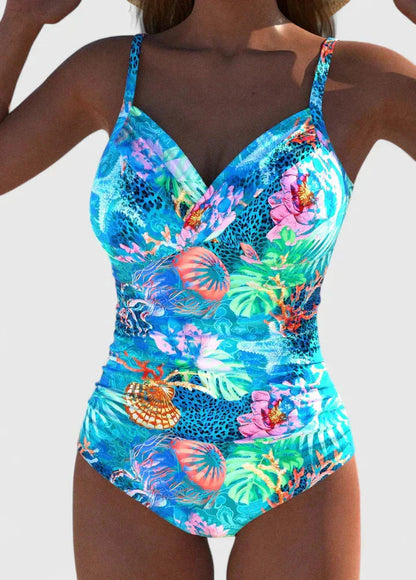 Women's tropical printed one-piece swimsuit with tie-back in bright blue with colorful coral and floral motifs, front view