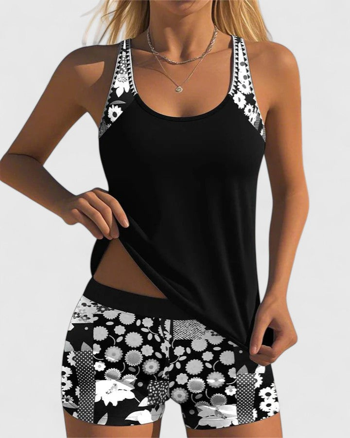 Black tankini with white daisy print straps and shorts front view