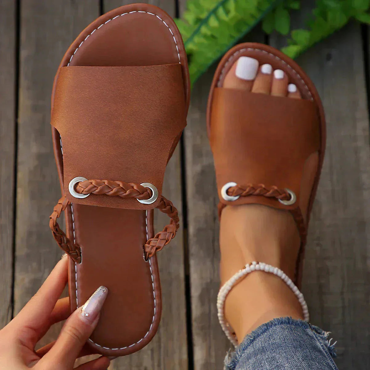 Tan leather slide sandal with braided strap and metal rings detail