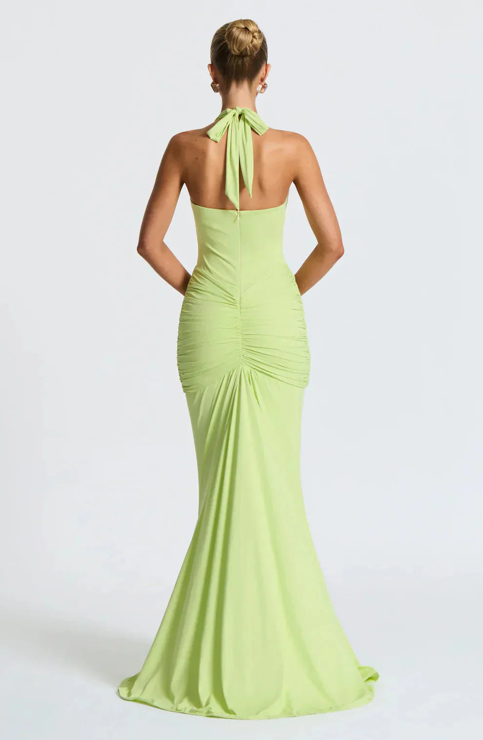 Back view of lime green halter maxi dress with tied neckline and ruched details