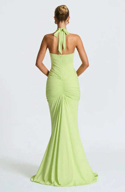 Back view of lime green halter maxi dress with tied neckline and ruched details