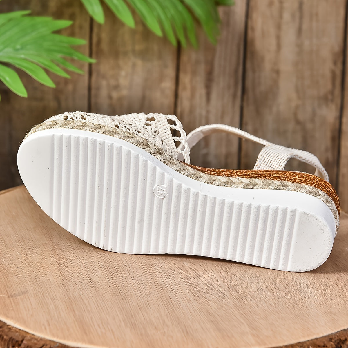 White ribbed sole of crochet lace sandal with rope trim and ankle strap