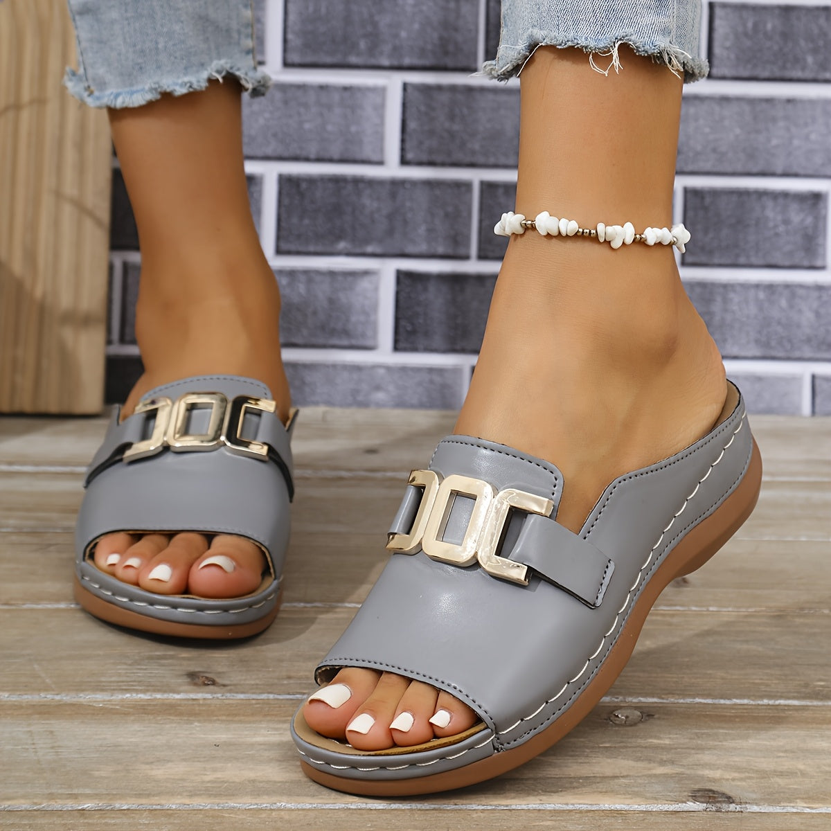 Gray buckle slide platform sandals with gold buckle detail and cushioned footbed