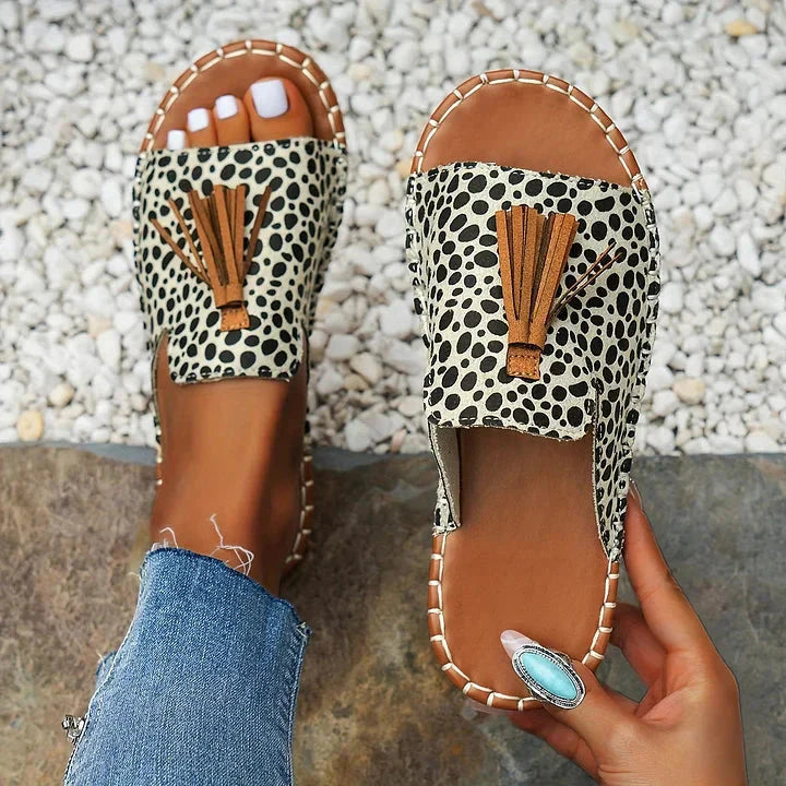 Black and cream spotted platform sandals with brown tassel, turquoise sole accent