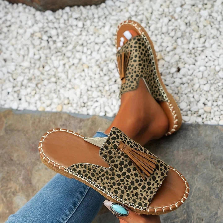 Leopard print platform sandals with tan tassel detail and stitched sole