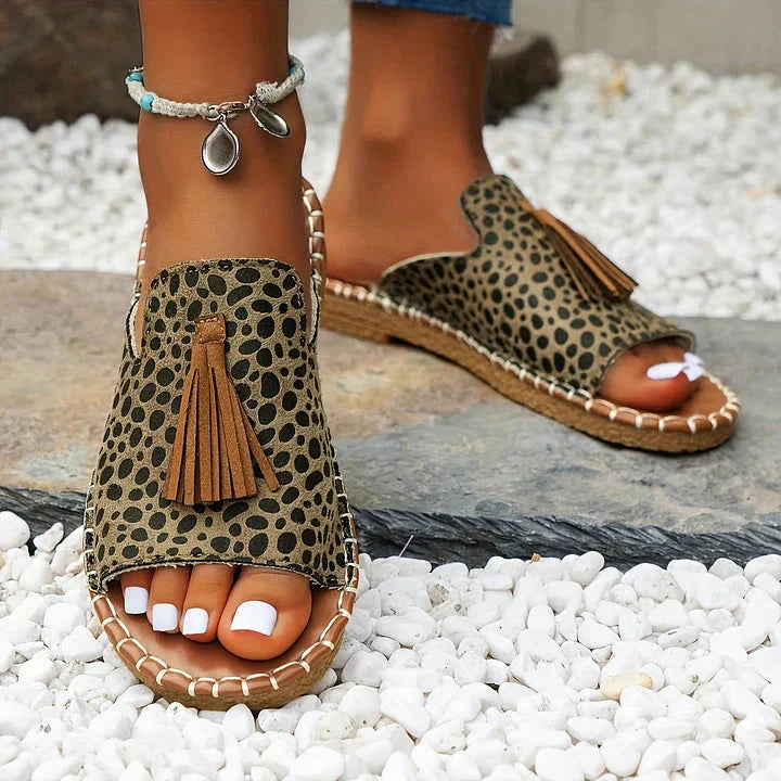 Leopard print platform sandals with tan tassel detail and stitched sole
