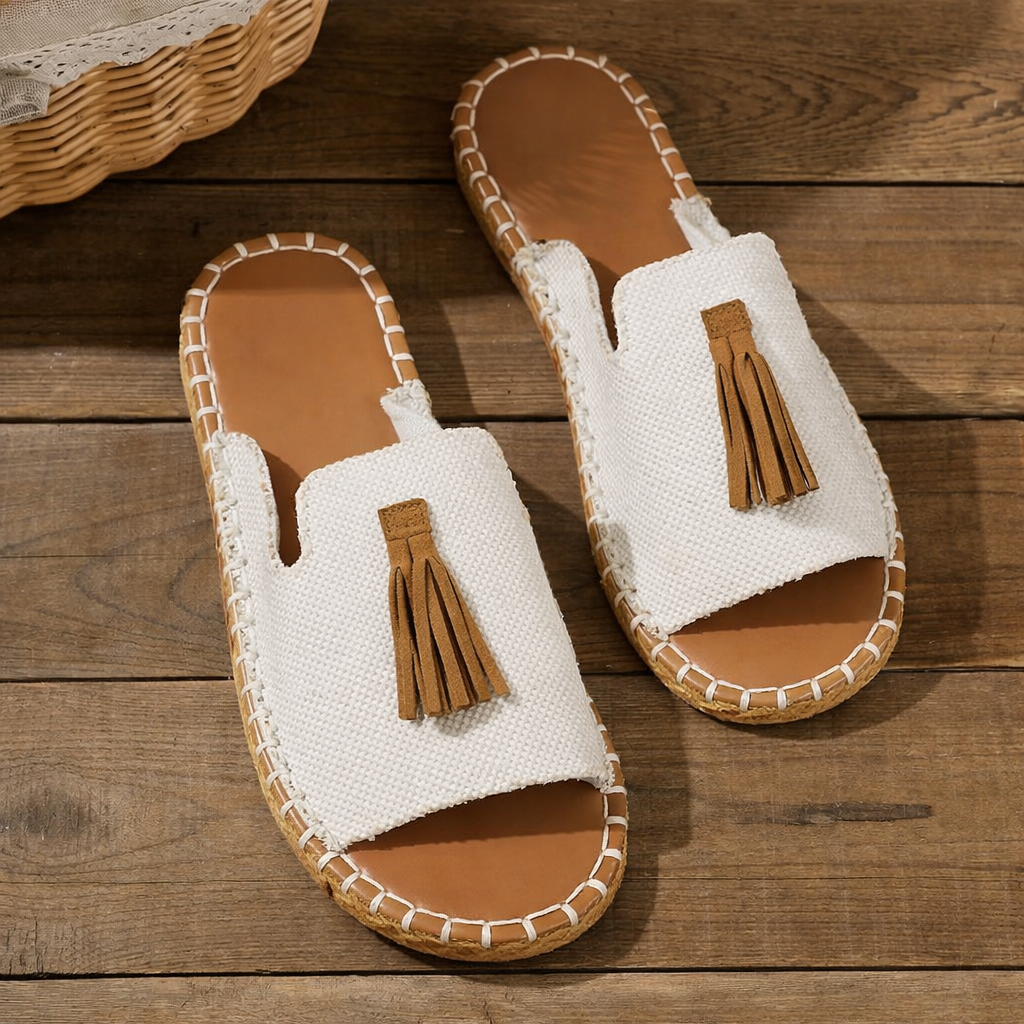 Cream linen platform sandals with brown tassel, cork sole, flat lay view