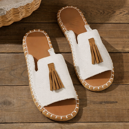 Cream linen platform sandals with brown tassel, cork sole, flat lay view