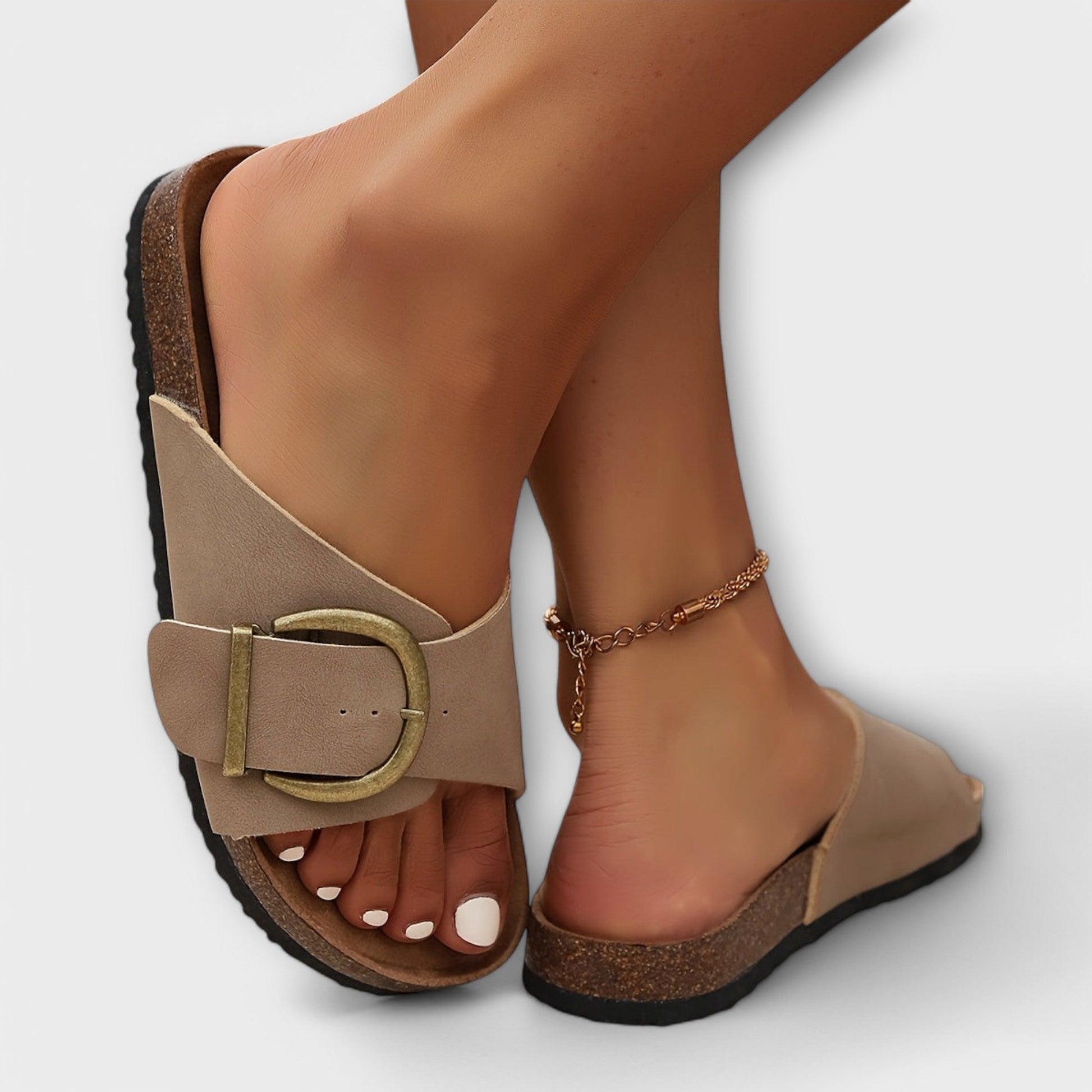 Beige buckle slide sandal with cork footbed close-up detail