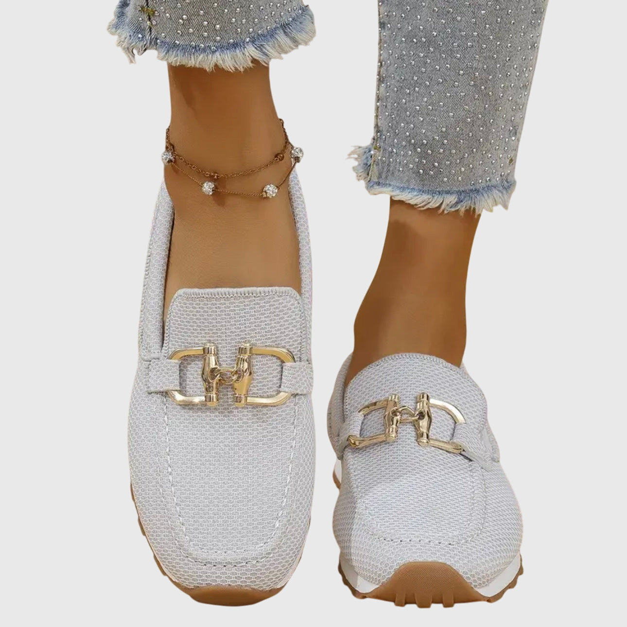 White mesh horsebit loafers with gold hardware, top-down view