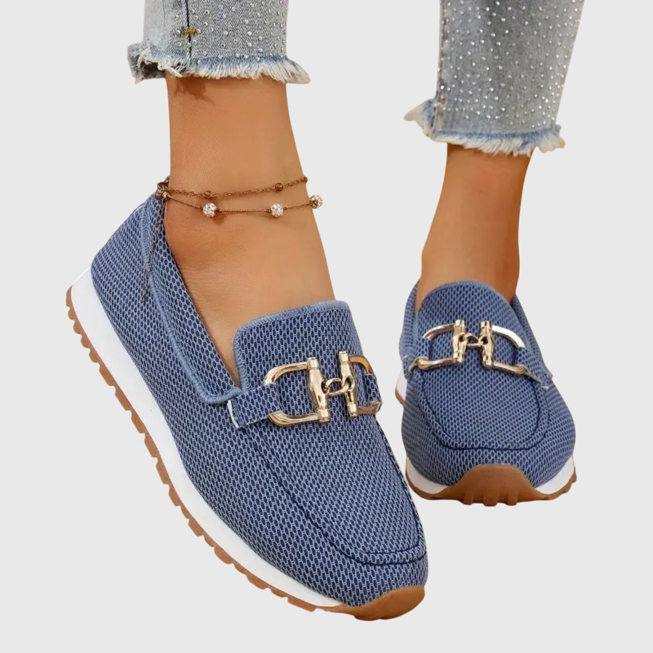 Blue mesh horsebit loafers with gold hardware and white sole, worn on feet