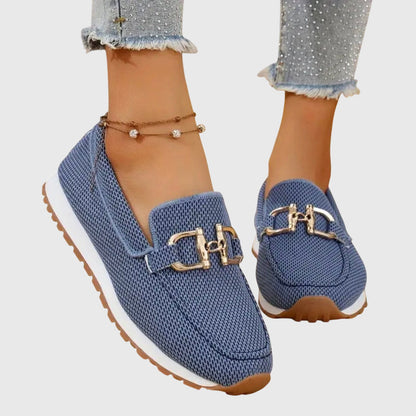 Blue mesh horsebit loafers with gold hardware and white sole, worn on feet
