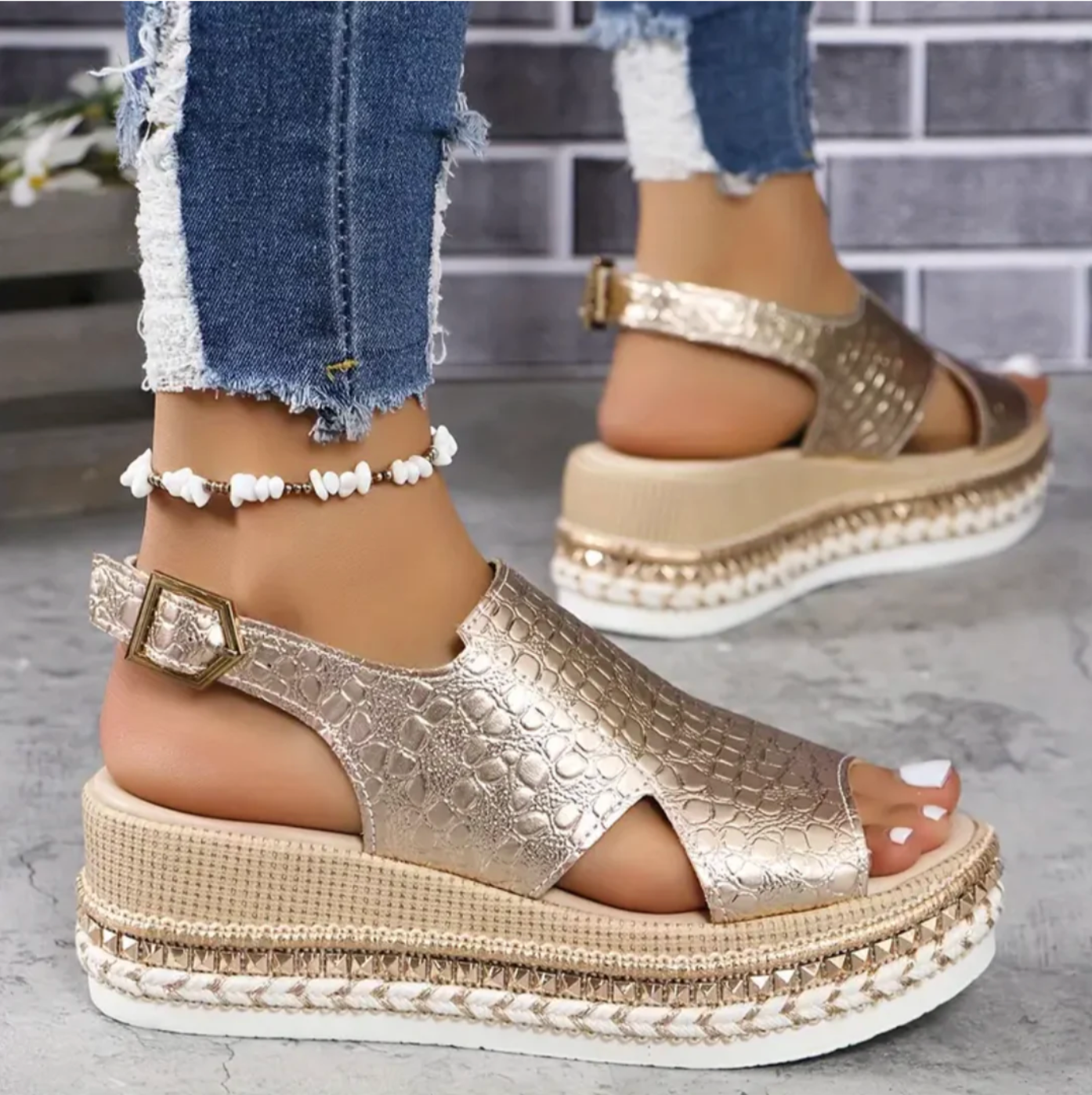Front angle of gold croc-texture platform sandals with adjustable ankle strap