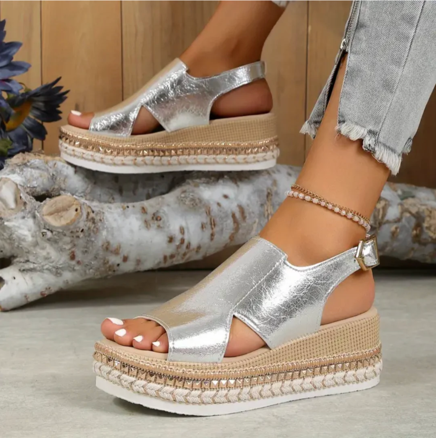 Silver metallic platform sandals with ankle strap on textured sole